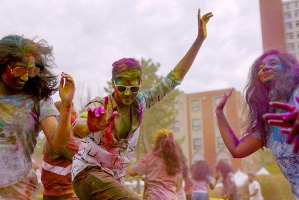 Chalk covered students celebrating Holi 2023 on the quad